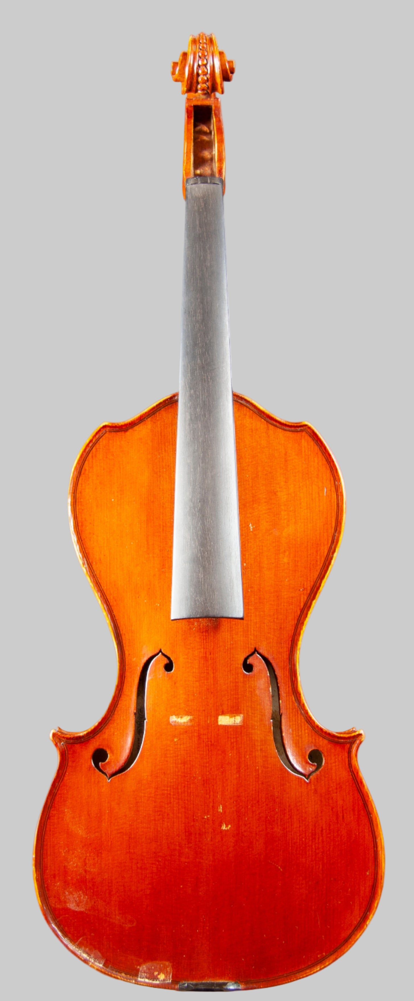 Violin on a stand against a dark background