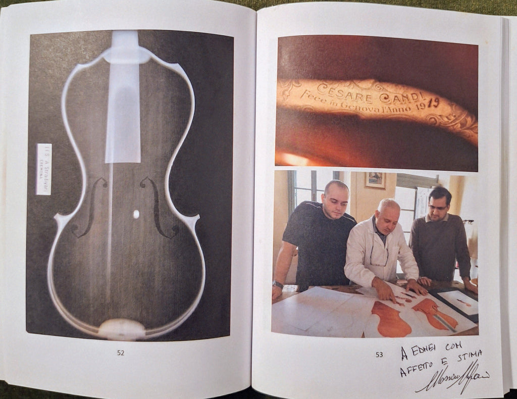 Open book showing images of a violin and people working on one, with text and signature.