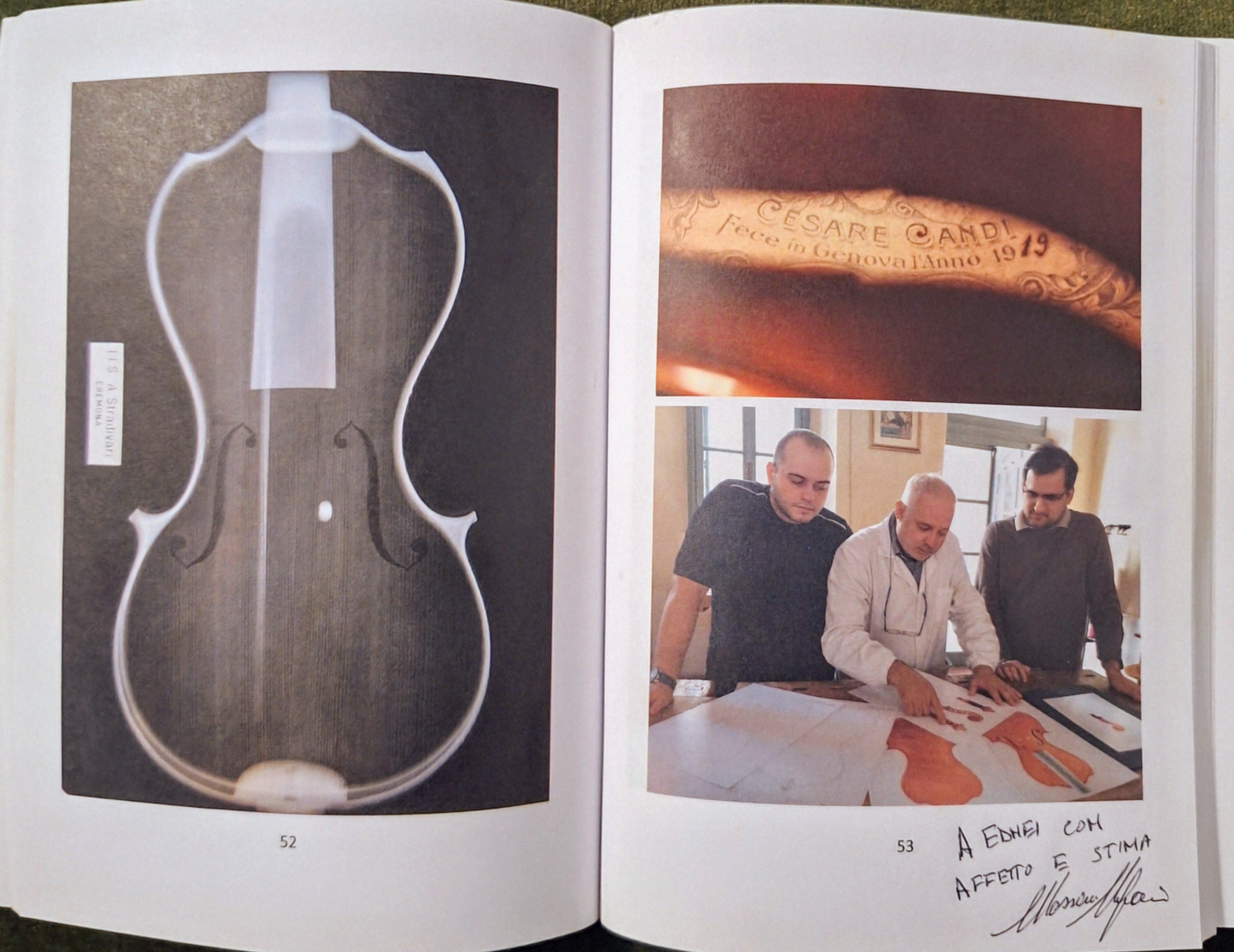 Open book showing images of a violin and people working on one, with text and signature.